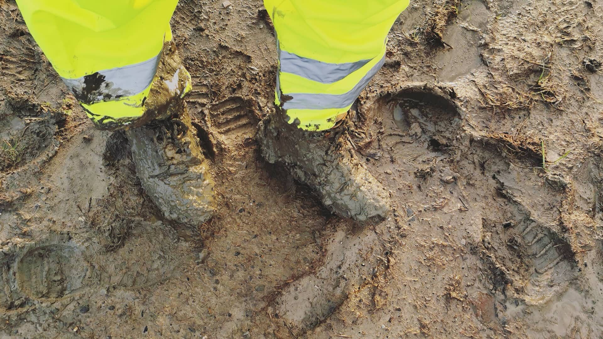 On set of a promo shoot for a windfarm, boots in mud
