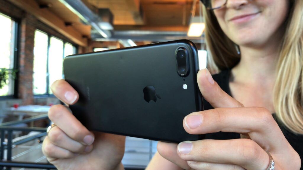 person filming on iPhone