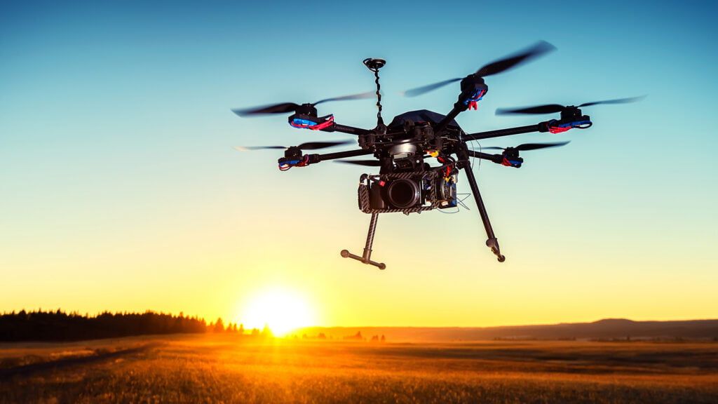 flying drone with sunset in background