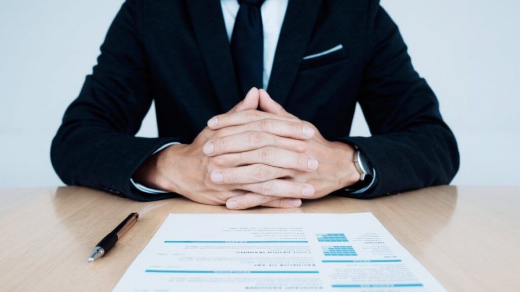 man sits with form in from of him