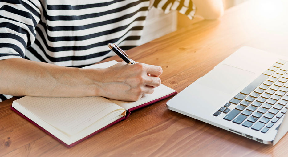 Person writing in notebook