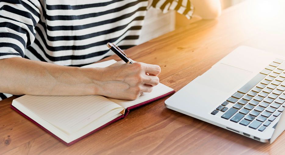 Person writing in notebook